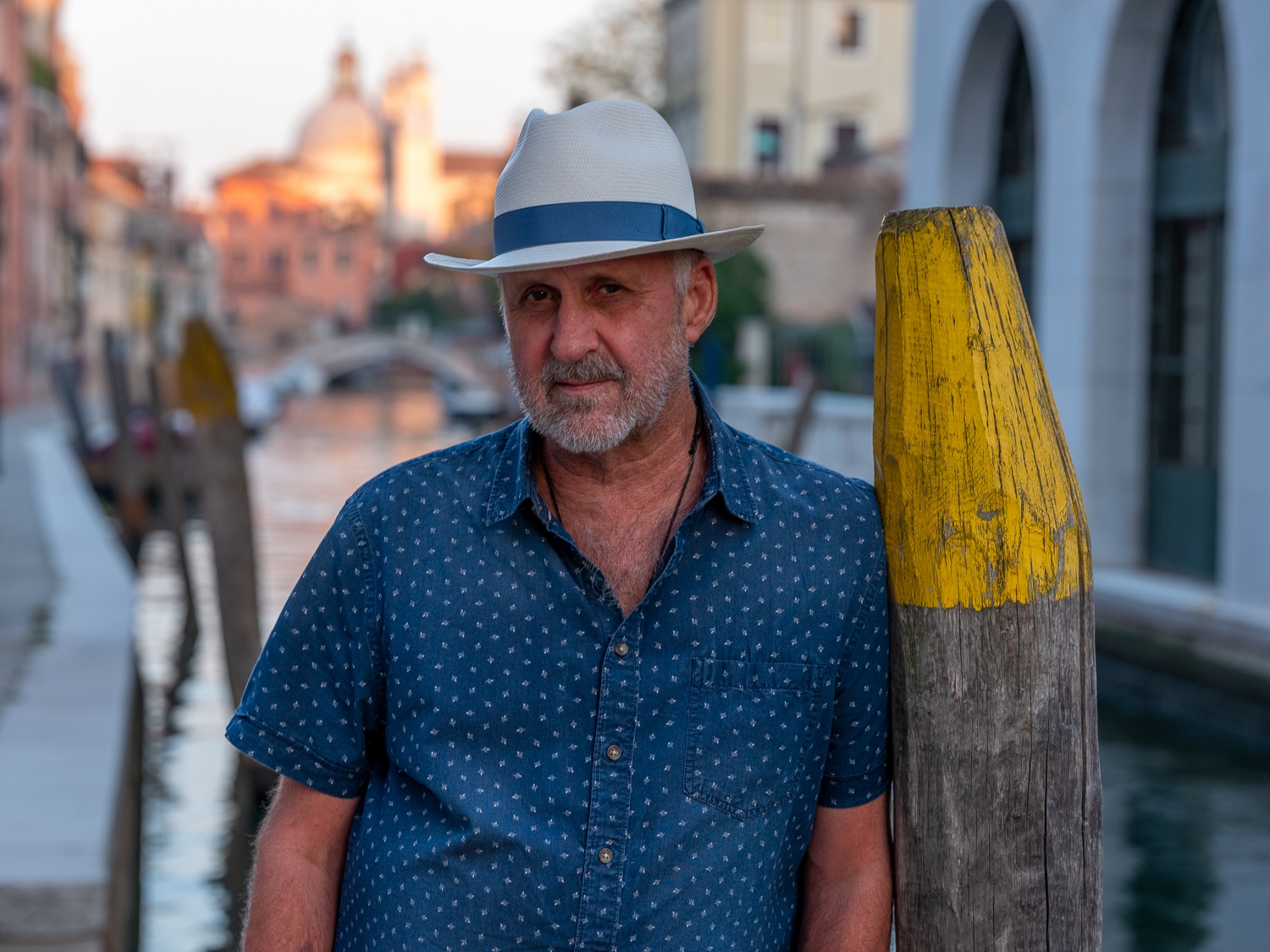 Tim in Venice leaning against yellow pole 2