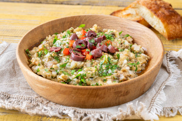 Bowl of Melitzanosalata greek eggplant dip garnished with olives